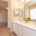 Primary bathroom vanity with dual sinks, expansive mirrors, and generous counter space. An ideal setup for busy mornings and everyday convenience.