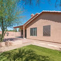 Private backyard featuring mature trees, easy-care landscaping, and a covered patio area. The outdoor setting offers room to relax, entertain, and enjoy the Arizona lifestyle.