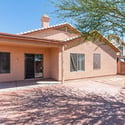 Covered outdoor living area paired with an extended paver patio and landscaped yard. Ideal for gatherings, outdoor dining, and year-round enjoyment in Phoenix.