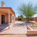 Attractive backyard with desert landscaping, mature shade trees, and generous patio space. Designed for low-maintenance living while maximizing outdoor enjoyment.