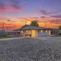Spacious backyard with an oversized covered patio, mature landscaping, citrus trees, and ample room for entertaining or future outdoor enhancements. Enjoy privacy and open space on this generous Goodyear property.