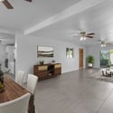 The virtually staged great room showcases an open floor plan with spacious living and dining areas, neutral finishes, tile flooring, and natural light that creates an inviting atmosphere for family and guests.