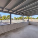 Covered front porch creates a welcoming entrance and comfortable outdoor sitting area overlooking the spacious front yard, offering the perfect place to relax throughout the year.