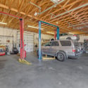 Spacious detached garage features automotive lifts, high ceilings, oversized work areas, and room for multiple vehicles, making it ideal for collectors, mechanics, business owners, or hobby enthusiasts in Goodyear.