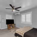 Bright guest suite features updated finishes, plantation shutters, mini-split cooling, and flexible living space ideal for visitors, extended family, or private accommodations.