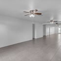 Expansive living room showcases the home's impressive scale with durable tile flooring, bright windows, and an open design perfect for entertaining family and friends.