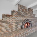 Beautiful full-height brick fireplace adds warmth and character to the home's spacious living area, creating an inviting gathering space with timeless architectural appeal.