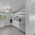 Updated kitchen offers granite countertops, stainless steel appliances, white cabinetry, and an efficient layout with ample workspace, creating a bright and welcoming heart of the home.