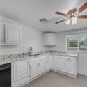 Spacious kitchen highlights granite countertops, abundant cabinetry, stainless steel appliances, and plenty of natural light, providing both style and functionality for daily living.