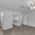 Renovated ensuite bathroom features a modern vanity, updated lighting, quartz-style countertop, and spacious walk-in tiled shower, delivering a clean and contemporary design.