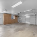 Large two-car garage provides abundant built-in storage cabinets, workspace, and parking flexibility, making organization easy for everyday living.