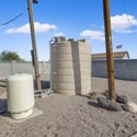 Private well and water storage system add convenience and support the property's outdoor functionality, complementing the spacious yard and practical amenities.