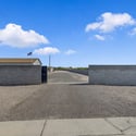 Spacious gated entrance provides secure access to the fully enclosed property with room for RVs, trailers, work vehicles, and additional parking while enhancing privacy in Goodyear.