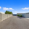 Long gravel driveway offers outstanding space for RV parking, trailers, boats, and guest vehicles while providing easy access through the gated entrance.
