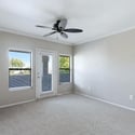 This open living room offers generous space for seating, natural light from multiple windows, and convenient access to the private balcony, blending indoor comfort with outdoor enjoyment.