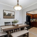 Virtually staged to inspire, the dining space comfortably accommodates family dinners while connecting seamlessly to the kitchen with rich cabinetry, ample storage, and updated appliances.