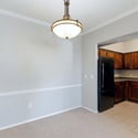 The kitchen and dining area provide an efficient layout with warm wood cabinetry, generous workspace, and modern appliances, creating a practical setting for everyday cooking and entertaining.