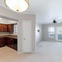 This bright interior showcases the seamless connection between the kitchen and living room, offering an ideal layout for entertaining, relaxing, and everyday living with plenty of natural light.
