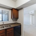 The kitchen opens directly to the living area, allowing natural light to flow throughout the home. Rich cabinetry, ample workspace, and updated appliances enhance both convenience and comfort.