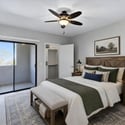 Virtually staged to inspire, this spacious primary bedroom features a private balcony, walk-in closet with built-in organization, and a calming atmosphere designed for rest and relaxation.