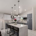 This modern kitchen blends sleek finishes with practical design, offering quartz countertops, stainless steel appliances, abundant cabinetry, and an open layout that complements today's lifestyle.