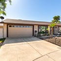 The attached two-car garage and wide driveway provide ample parking for residents and guests while enhancing the home's convenience, functionality, and overall curb appeal in Scottsdale.
