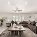 The bright great room offers generous seating space, contemporary finishes, and seamless access to the kitchen. Large windows fill the Scottsdale home with natural light for comfortable everyday living.