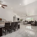 This expansive dining area blends effortlessly with the great room, creating flexible living space for entertaining or everyday meals. Bright interiors and vaulted ceilings enhance the Scottsdale home's appeal.