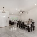 Host memorable dinners in this spacious dining room featuring beautiful tile flooring, soaring ceilings, and an open layout that connects naturally with the main living spaces of this Scottsdale home.