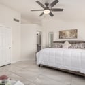 This welcoming primary suite offers generous dimensions, vaulted ceilings, plantation shutters, and easy access to the private ensuite bathroom. A peaceful retreat within this move-in ready Scottsdale home.