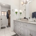 Elegant primary bathroom with dual sinks, granite countertops, custom cabinetry, and updated fixtures. This spacious vanity area offers both style and functionality for everyday living in Scottsdale.