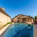 Expansive backyard with a refreshing pool, attached spa, covered patio, and easy-care landscaping offers plenty of space for outdoor gatherings and everyday enjoyment in Scottsdale.