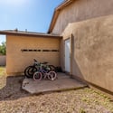 Convenient side yard with exterior door access, gravel ground cover, and room for storage or utility use. An added functional feature that complements the outdoor layout of this Scottsdale home.