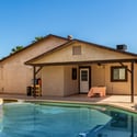 Relax and entertain beside the sparkling swimming pool with a covered patio and generous outdoor living space. This Scottsdale backyard is designed for year-round enjoyment and memorable gatherings.