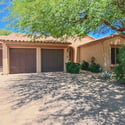 Arrive home to impressive curb appeal with a paver driveway, mature landscaping, and an oversized garage. This elegant residence is situated within a desirable gated Scottsdale neighborhood.