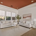 A welcoming formal sitting room offers elegant finishes, oversized windows, and versatile living space that provides comfort while enhancing the home's sophisticated floor plan.
