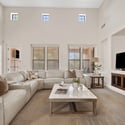 Gather beneath soaring ceilings in this spacious family room featuring a fireplace, built-in entertainment center, and abundant natural light. The open-concept design is ideal for everyday living and entertaining.