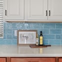 Premium quartz counters, abundant cabinetry, and a handcrafted tile backsplash highlight the upscale finishes found throughout this gourmet kitchen, offering both beauty and everyday functionality.