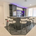 Premium granite surfaces, custom cabinetry, built-in storage, beverage sink, and stylish finishes make this wet bar the centerpiece of the home's entertainment level.