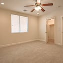 This spacious basement bedroom offers plush carpeting, ceiling fan, recessed lighting, a walk-in closet, and versatile space ideal for guests, hobbies, or a private home office.