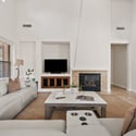 Gather in the spacious family room with soaring ceilings, a cozy fireplace, built-in media center, and an open layout that enhances both comfort and functionality throughout the home.