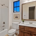 Featuring a full tub and shower, generous vanity, and quality finishes, this secondary bathroom offers convenience, comfort, and natural light for family members and guests.