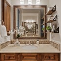 Premium cabinetry, stone countertops, floating shelves, and decorative tile details showcase the craftsmanship and thoughtful design throughout this elegant Scottsdale primary bathroom.