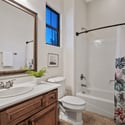 This well-designed full bathroom includes a spacious vanity, tub and shower combination, oversized mirror, and quality finishes that provide comfort and convenience for family and guests.