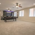 The expansive basement provides exceptional flexibility with room for entertaining, recreation, gaming, or media while showcasing custom finishes and an adjoining wet bar in this Scottsdale home.