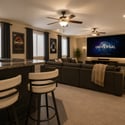 Virtually staged to inspire, this spacious basement demonstrates the possibilities for a luxurious home theater, lounge, and entertainment space centered around the custom wet bar and open-concept layout.