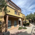 Beautiful former model townhome with attractive architecture, mature landscaping, and a covered front entry located within the desirable gated Villa Milano community in Phoenix.