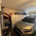An attached two-car garage offers built-in storage cabinets, rear vehicle entry, and ample space for parking, tools, and seasonal storage, adding everyday convenience to this Phoenix home.