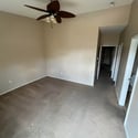 A spacious primary bedroom with vaulted ceilings, neutral finishes, and comfortable carpeting offers a versatile space ready for your personal style.