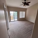 This bright primary suite includes sliding glass doors to the private balcony, vaulted ceilings, and generous floor space, creating an inviting owner's retreat.